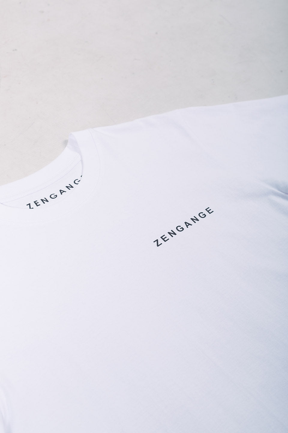 Zengange Premium – White colored T-shirt with orange details.